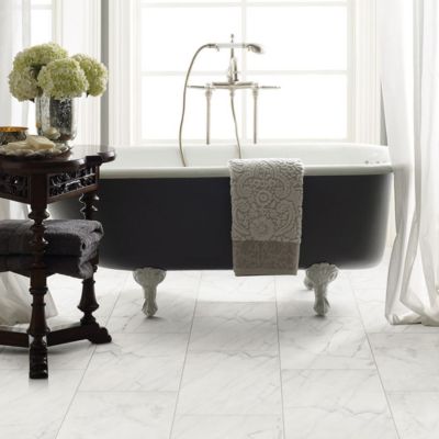 white marble look tile flooring in an elegant breezy bathroom with a tub